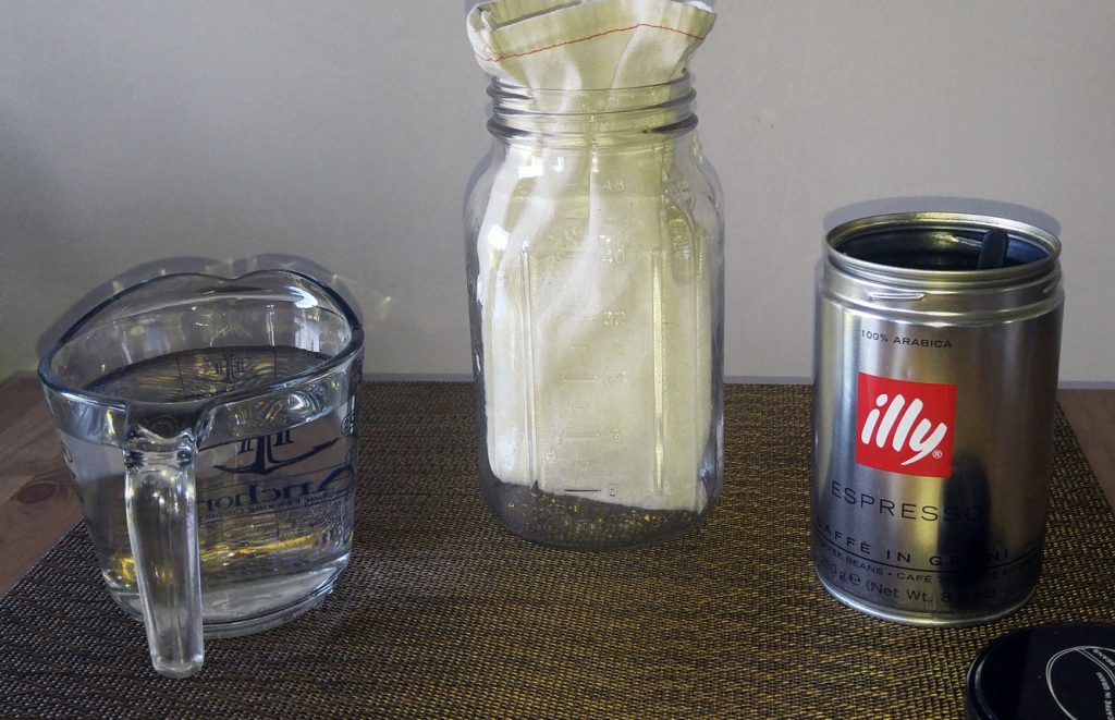 Starting a Cold Brew Batch Cold brewing coffee with a cotton coffee bag and a mason jar